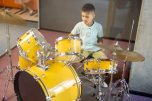 menino tocando em bateria de verdade garotinho tambores se divertindo enquanto visitava um museu ciência 302960924